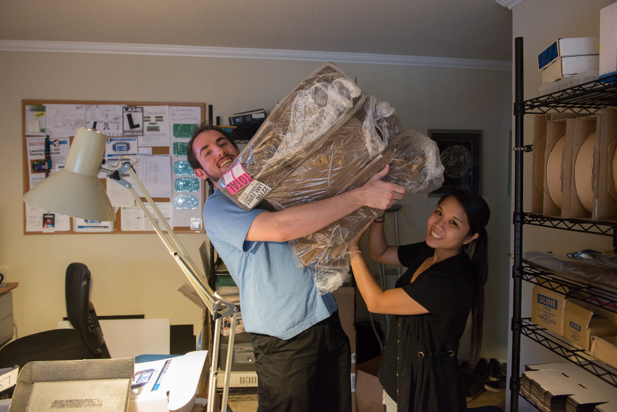 Moving piles of stuff in the warehouse / living room. Pay close attention to the blue shirt.