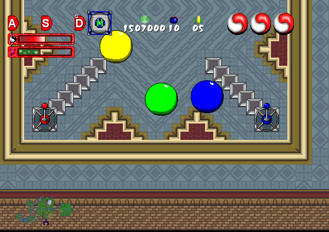 A medieval-themed game arena with three brightly colored spheres spinning and colliding.